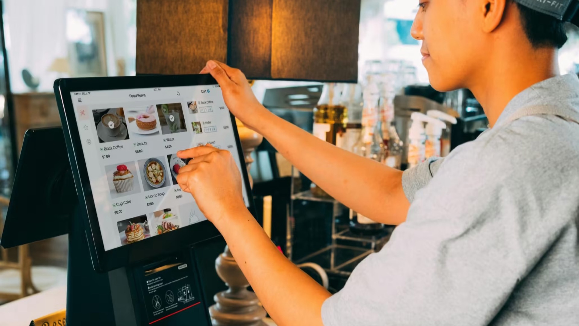 Restaurant worker entering an order on a touchscreen