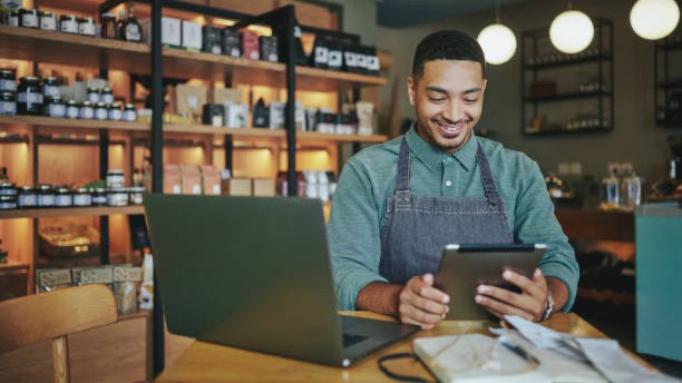 Shop owner reviewing sales on a tablet