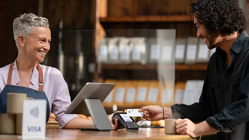 Customer tapping a card to pay at a small business